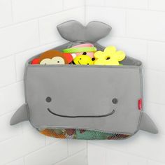 a gray whale shaped storage bag filled with toys