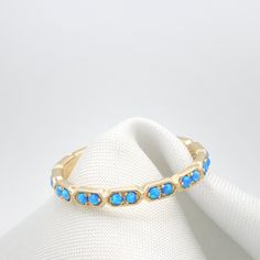 "Opal Eternity Gold ring set with 18 Real Dark Blue opal gem stones. Stunning 18 stone ring with a delicate handmade texture all around the stones. Beautifully Set with Dark Blue Opals and ready to wear alone or as a stacking ring. The back of the ring is Made of a straight line, This allows me to resize the rings quickly and should be inside your palm when you wear this Eternity ring. Lovely Everyday ring with Presence, Elegance and sheer beauty. Perfect for Stacking together with Another ident Elegant Adjustable Opal Stackable Rings, Adjustable Stackable Rings With Gemstone Accents, Blue Opal Stackable Ring For Promise, Opal Gemstone Stackable Rings For Anniversary, Blue Stackable Opal Ring For Promise, Fine Jewelry Stackable Opal Ring With Round Band, Blue Stackable Opal Promise Ring, Adjustable Opal Stackable Rings, Stackable Opal Ring Jewelry