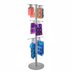 three shopping bags are hanging on a metal pole with four different colored tags attached to it