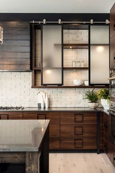 a kitchen with wooden cabinets and white tile backsplash