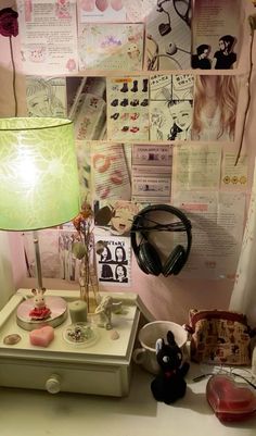 a desk with a lamp and some pictures on the wall