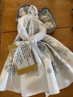 a white and gold gift bag on a wooden table