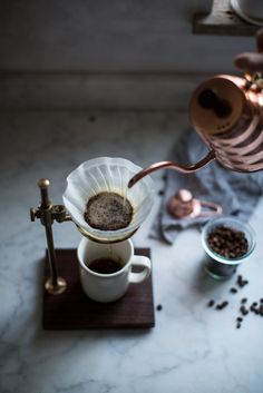 coffee being poured into a white cup