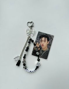 a necklace with a photo and charms attached to it