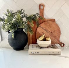 a white counter topped with a bowl of food and a cutting board