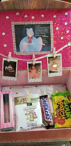 a pink suitcase with pictures and candy on it