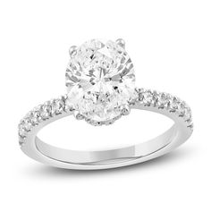 an oval cut diamond engagement ring with pave set shoulders