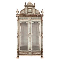 an ornate display cabinet with glass doors and carvings on the front, in white background