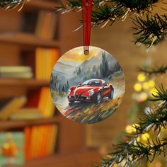 a red car ornament hanging from a christmas tree