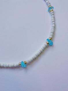 Dainty handmade beaded choker necklace with gemstone and bead pattern. This necklace featuring sparkling gemstones adds a pop of color to any outfit and is perfect to wear to the beach! Grab multiple colors to match your bathing suits and beach outfits. Necklace features: 13.5 inches in length with a 2 inch extender chain White seed beads with galvanized gold seed beads surrounding each gemstone bead Colors: Amazonite: matte blue/green Amethyst: dark purple Aquamarine: light blue Aventurine: lig Seed Bead Gemstone Necklace, Adjustable Heishi Beads Choker For Beach, Beaded Choker With Round Beads For Beach, Blue Round Beads Choker For Beach, Summer Beach Beaded Necklaces With Gemstone Beads, Beaded Strand Choker For Vacation, Beaded Strand Choker For Beach, Beach Choker With Round Beads, Adjustable Beaded Strand Choker