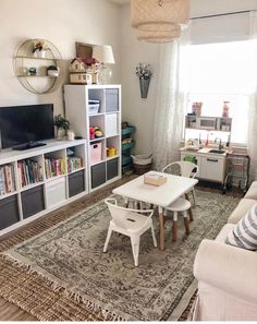 a living room filled with furniture and a white table