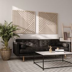 a living room with two black couches and a coffee table