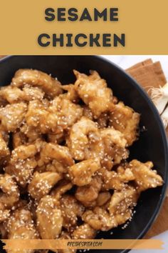 sesame chicken in a black bowl on top of a table