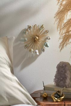 a bedroom with white walls and gold decorations on the wall, along with a bed