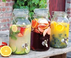 three mason jars filled with drinks sitting on top of a table next to each other