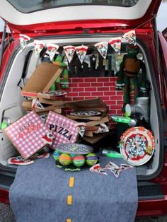 the trunk of a red car filled with items