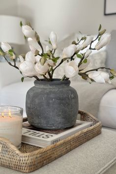 a candle and some flowers on a tray