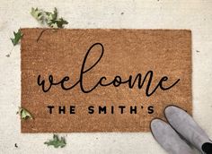 someone is standing on the door mat that says welcome to the smith's