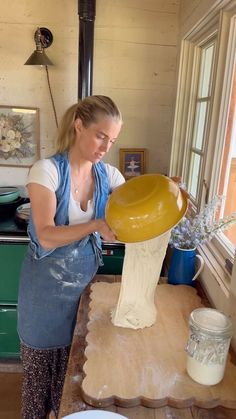 a woman is working on an object in the kitchen