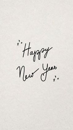 the words happy new year written in black ink on a white paper with stars around it