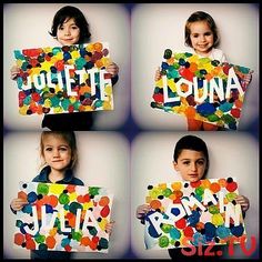 four children holding up signs that spell out the name jolie - ti, julia, and john