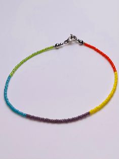 "Our Rainbow Dreams Beaded Anklet is so so fun This super cool anklet rocks five different color seed beads and is sure to compliment many outfits This beautiful anklet is designed with Czech Glass Seed Beads in five different colors and Sterling Silver Beads. This Anklet comes with a Sterling Silver Lobster Clasp. We all need a  rainbow of colors in our life, why not treat yourself or that special someone with a fun and colorful anklet. When ordering an anklet from LAMM Creations, the best way to determine what size to order, is to measure your ankle either above or below your ankle bone whichever you prefer using a flexible measuring tape or cloth. If you don't have a flexible measuring tape available, you can use a string or cloth, and mark it where it overlaps on your ankle. Then using Rainbow Anklet, Seed Bead Anklet, Bead Anklet, Beautiful Anklet, Summer Anklets, Beaded Anklet, Anklets Boho, Beach Anklets, Beaded Anklets