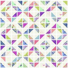 a quilt with many different colored triangles on it