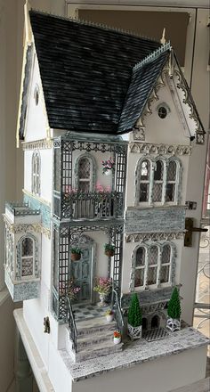 a doll house is shown on top of a table