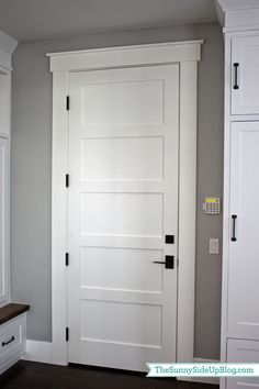 a white door in the corner of a room