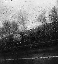 black and white photo of rain drops on window