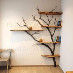 an empty room with bookshelves and branches on the wall