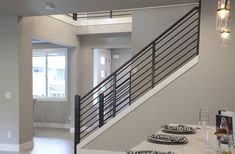 an open floor plan with stairs and dining table