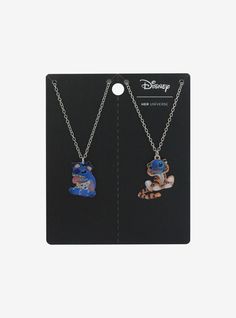 two necklaces with cartoon characters hanging from the same chain, one on each side