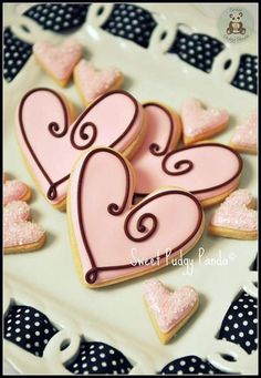 decorated cookies in the shape of hearts on a plate