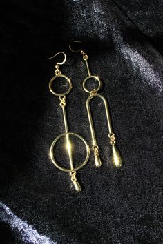 These mismatched earrings are modern and fun. If you are a minimalist with a flair for all things quirky, these are for you.  The earrings are slightly different in shape and size but nearly identical in weight, so the asymmetry of the design will not cause you any discomfort. However, if you're not a fan of mismatched earring styles, you'll have an option to order a matching pair - just select your preferred option before checkout. You'll also have to select your ear wire option before checkout. Vermeil is gold plated sterling silver. "Gold-filled" means a thicker coating of gold over a base metal. The 14kt gold-filled hooks I offer have a tiny hallmark. You won't be able to read it without a magnifying glass but you can feel it with your finger. Gold-plated hooks are made of copper wire Geometric Metal Earrings For Everyday, Minimalist Gold Metal Plug Earrings, Minimalist Gold-tone Metal Earrings, Trendy Gold Linear Earrings, Modern 14k Gold Filled Dangle Earrings, Minimalist Metal Linear Earrings For Party, Gold Geometric Earrings For Everyday, Minimalist Gold Plated Drop Earrings, Modern Gold Long Drop Hoop Earrings