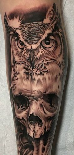 an owl and skull tattoo on the leg