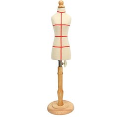 a mannequin on a wooden stand with red lines