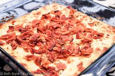 a square pizza sitting on top of a pan covered in toppings