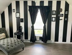 a black and white striped room with a chaise lounge in the corner, chandelier hanging from the ceiling