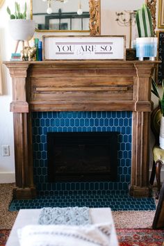 a fireplace with a sign that says you are so above it and some potted plants