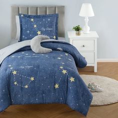 a bed with blue and yellow stars on the comforter, pillows and pillow cases