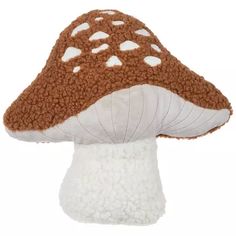 a brown and white mushroom with hearts on it's side, sitting in front of a white background