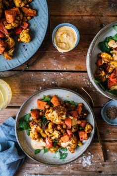 two bowls filled with food on top of a wooden table