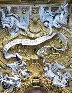 an ornately decorated ceiling with angels and mermaids on it's sides, in black and white