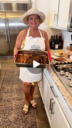 a woman in an apron holding a tray of food