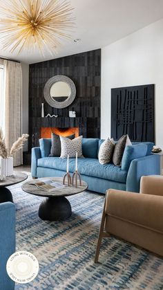 a living room filled with blue couches and chairs