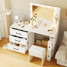 a white dressing table with drawers and stools