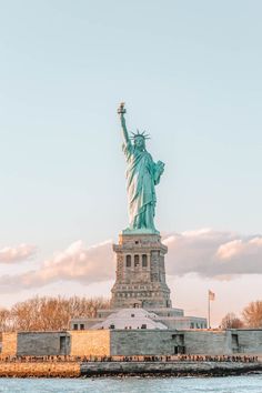 the statue of liberty in new york city, ny is shown from across the water