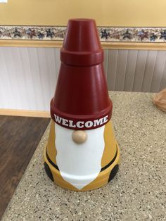 a red and white fire hydrant sitting on top of a counter