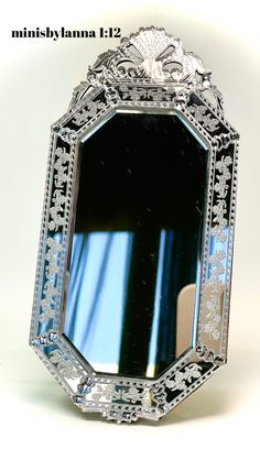 an ornately decorated mirror is shown against a white background with the reflection in it